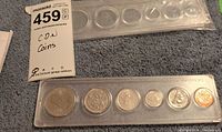 Full view of six-coin set in plastic holder with blank spare holder above
