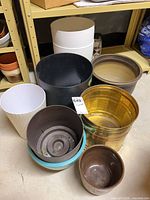 Group of eight assorted planters showing sizes and colors
