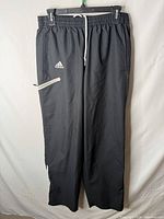 Full view front of Adidas black track pants