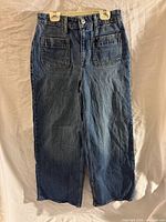 Full front view of jeans showing style, color and length