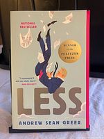 Front cover of Less paperback showing title, author, Pulitzer Prize medallion