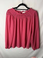 Front view of LOFT fuchsia chiffon blouse on hanger