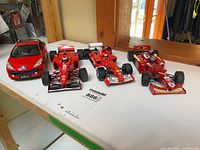 All four 1:18 model cars on table