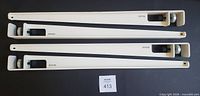 All four white metal TIPTOE legs side by side showing full length and hardware