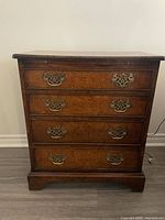 Four-drawer wooden bureau with brass batwing pulls