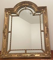 Front view of French giltwood mirror showing full frame and glass