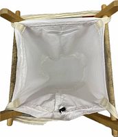 Top view of white canvas hamper bag attached to wooden frame
