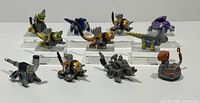 Group shot of all 11 Dinotrux Reptool Rollers on acrylic blocks