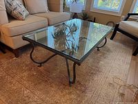Full view of glass top coffee table in living room setting