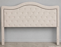 Front view of ivory tufted queen headboard showing fabric, tufting, nailhead trim and legs