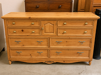 Front view of pine dresser showing drawer and cabinet layout with hardware