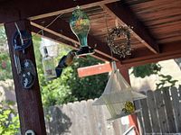 Overall view of multiple hanging items under patio beam