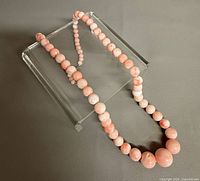 Full graduated angel skin coral bead necklace laid flat