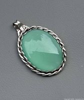 Front view showing green chalcedony cabochon and sterling frame