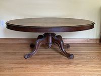 Full side view showing carved pedestal and legs
