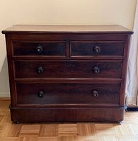 Front view showing all four drawers, knobs, and overall finish