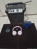 Group shot showing Ion Job Rocker Plus speaker, JBL headphones, JBL earbuds, 808 speaker
