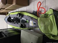 Inflated green-grey ITIWIT kayak showing interior seats, orange hose, electric pump and carry bag