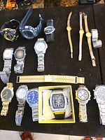 Overview of all 17 watches on black surface