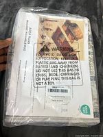Front of sealed package with warning label and specification sheet