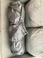Rolled grow tent in carry bag on sofa