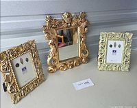 Front view of all three ornate gold frames and mirror