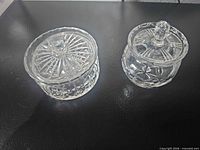 Both glass containers side by side showing size difference and cut pattern