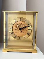 Front view showing full brass and glass clock with Bank of Montreal dial