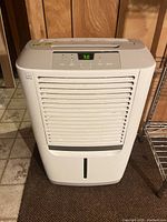 Front view showing Kenmore logo, louvered intake, bucket slot