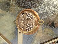 Front view of large copper mold showing wheat design and brass loop