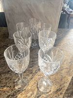 Front angled view of all seven crystal wine glasses