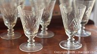 All five Webb Corbett crystal juice glasses grouped on table showing design and quantity