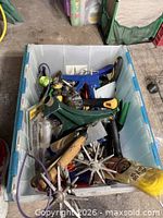 Overall view of plastic tote filled with assorted tools