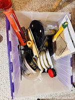 overview of tote with assorted painting tools including pipe wrench and sanding block