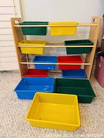 Full view of wooden organizer with bins arranged plus one bin placed in front