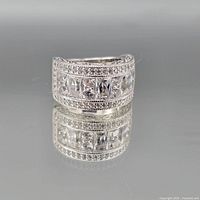 Front view of sterling silver eternity ring showing channel-set cubic zirconia and milgrain edges