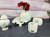 Group shot of all porcelain pieces displaying bird motif