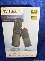 Front of sealed retail box showing TV Stick 4K, remote, 4K/1080p icons