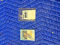 Card and plastic top-loader on blue padded surface