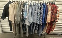 Full rack showing all 25 shirts on hangers