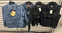 Front view of all four denim jackets on hangers