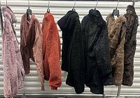 All seven outerwear pieces hanging for overview