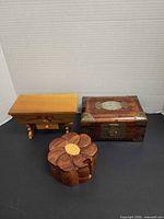 Group shot of all three wooden boxes closed