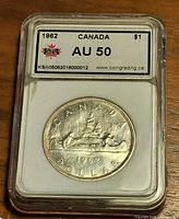 Front of KSA slab with coin reverse and AU50 label