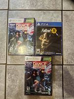 Front view of three sealed game cases: two Dance Central Xbox 360 and one Fallout 76 PS4