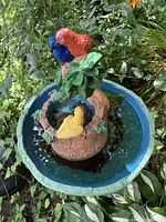 Top view of resin bird bath basin showing blue interior, centerpiece with birds and foliage