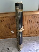 Full view of rolled rubber matting standing upright, taped