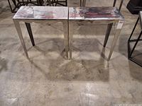 Front angled view of both nesting tables on concrete floor