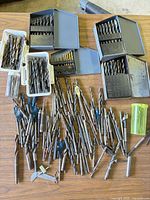 overview of drill bits, index cases, loose bits and storage containers on table