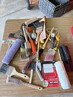 Top view assortment of brushes, roller covers, scrapers, tools